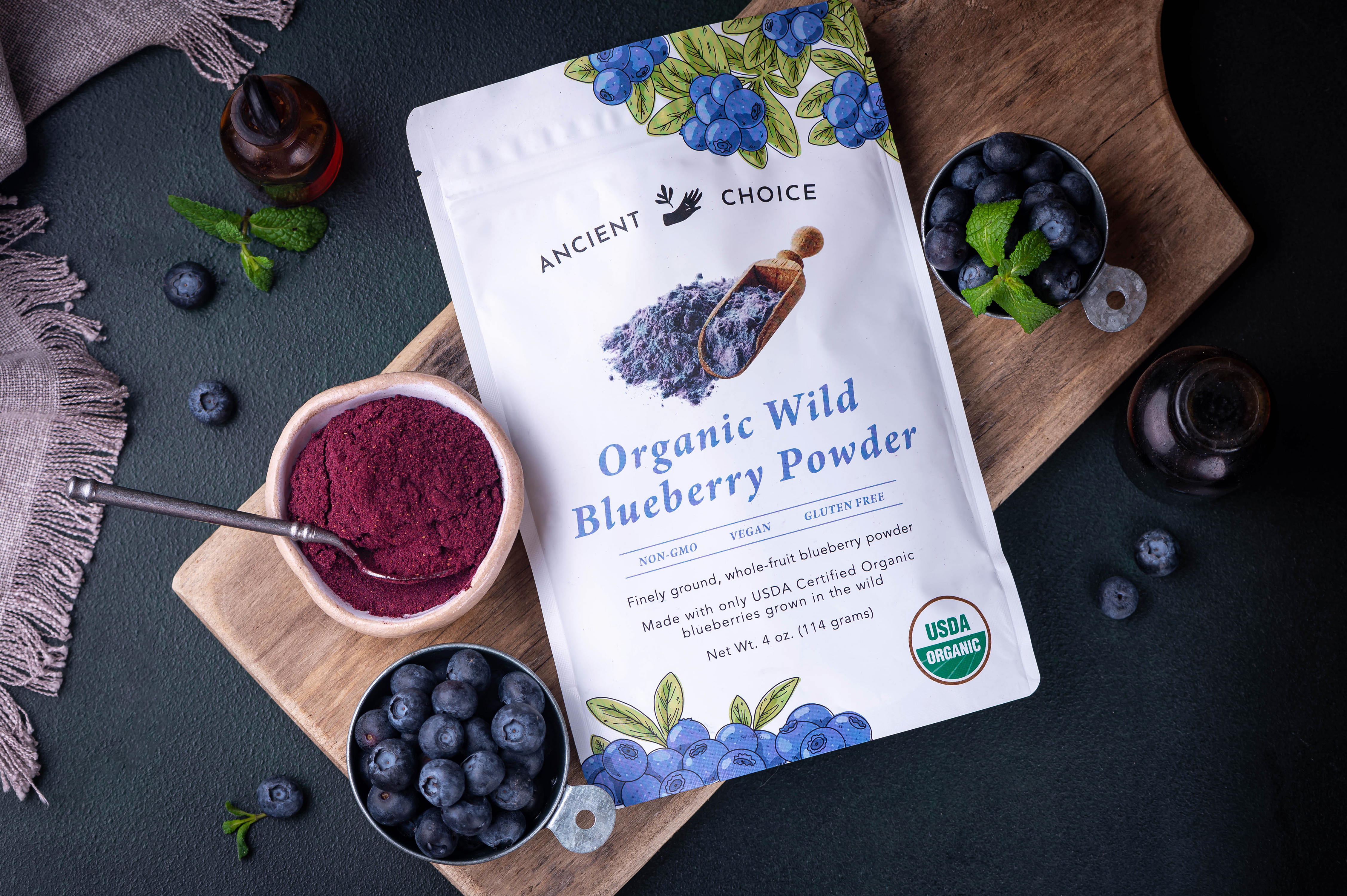Ancient Choice Organic Wild Blueberry Powder, 4 oz pouch, with fresh blueberries and mint.